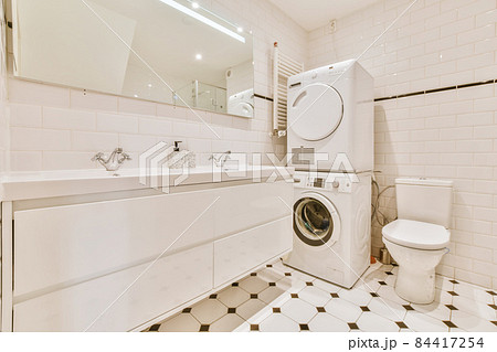 Adorable bathroom with laundry area and large sink for two 84417254