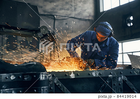 Fitter working with special machine for welding metal.  84419014