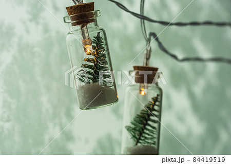 Christmas garland - Christmas tree in a glass jar on a dark background 84419519