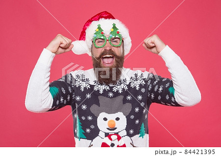 cheerful party goer in santa hat and knitted sweater feel joy and prepare for christmas cheerful party goer in santa hat and knitted sweater feel joy and prepare for christmas 84421395