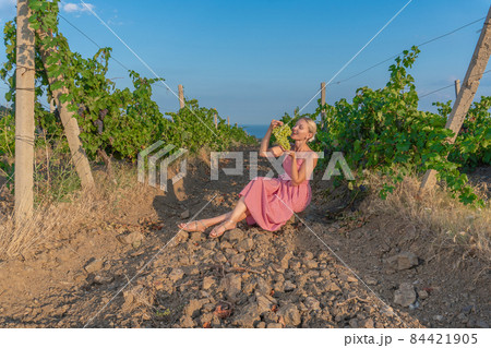 Girl in vineyard and mountains sky earth rural grape harvest sky, autumn scenic. Person county, farmer Girl in vineyard and mountains sky earth rural grape harvest sky, autumn scenic. Person county, farmer 84421905
