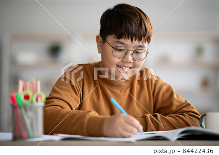schooler Joyful asian schooler doing homework, writing...の写真素材 [84422436] - PIXTA