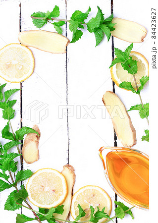 ginger honey lemon mint on a white wooden background ingredient for homemade lemonade rustic style flat look view from above over head ginger honey lemon mint on a white wooden background ingredient for homemade lemonade rustic style flat look view from above over head 84423627