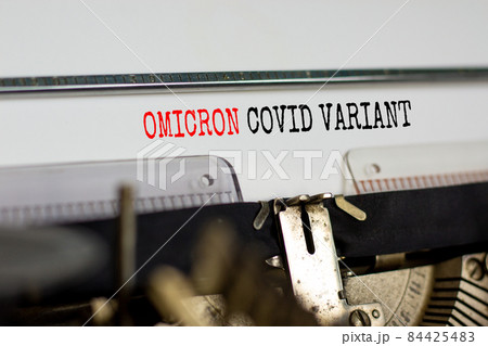 Covid-19 new omicron virus variant symbol. Concept words Omicron covid variant typed on retro typewriter. Medical and COVID-19 pandemic new omicron variant strain mutation concept. 84425483