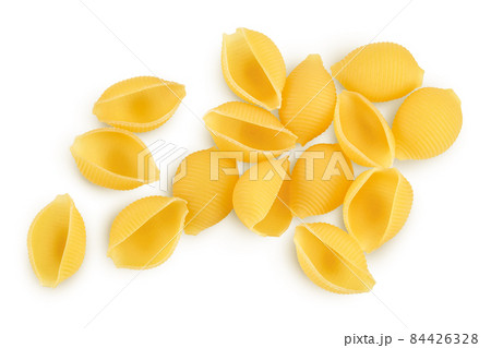 Uncooked dried conchiglie. Raw organic shell pasta isolated on white bachground with clipping path and full depth of field. Top view. Flat lay 84426328