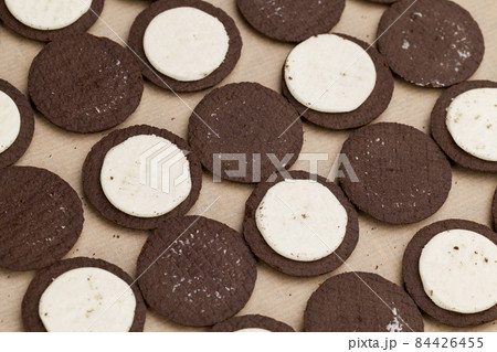 chocolate cookies with creamy cream filling chocolate cookies with creamy cream filling 84426455