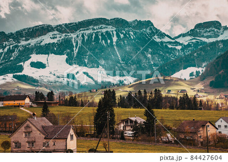 small mountain village and snowy Alps Switzerland small mountain village and snowy Alps Switzerland 84427604