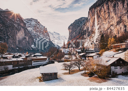 amazing touristic alpine village in winter with famous church and Staubbach waterfall  Lauterbrunnen  Switzerland  Europe 84427635