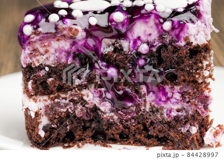 covered with blackberry jam chocolate cake with buttercream 84428997
