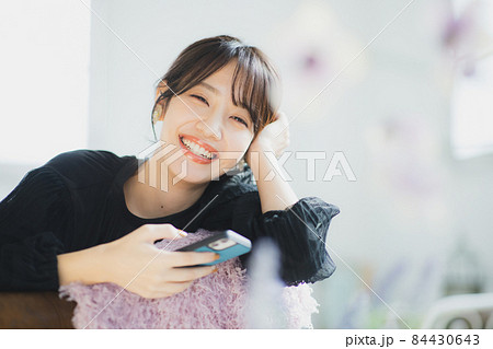 スマホを見る女性 84430643