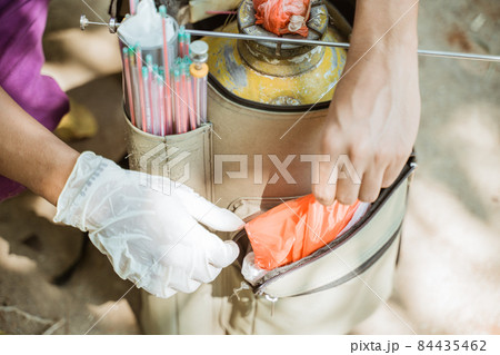 hand preparing the tools for artificial insemination of cow. 84435462