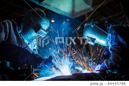 Teamworker with protective mask welding metal 84435766