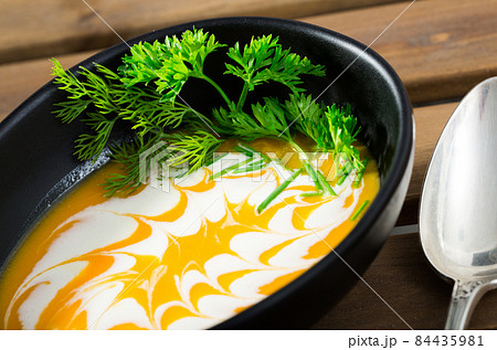 Close up of cooked homemade vegetable pumpkin and ginger cream soup 84435981