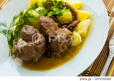 Prepared with mushrooms and potatoes tasty lamb served with greens Prepared with mushrooms and potatoes tasty lamb served with greens 84436686