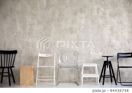 Row of different chairs in empty studio 84436748