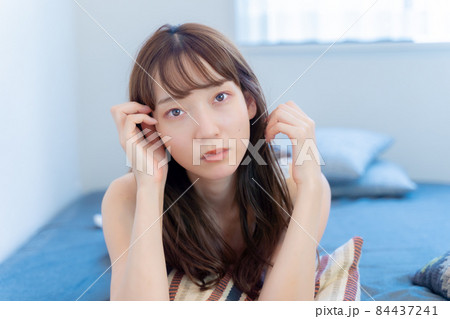 真顔で見てくるうつ伏せの女性 真顔で見てくるうつ伏せの女性 84437241