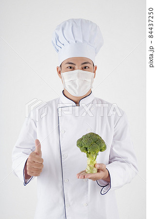 Positive Chef Holding Fresh Broccoli 84437250