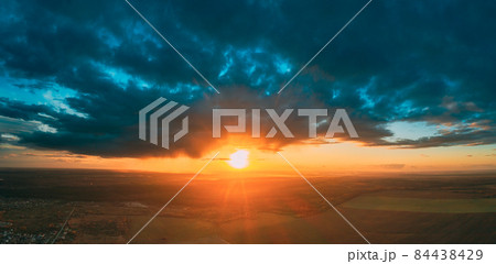 Aerial View Of Sunshine In Sunrise Bright Dramatic Sky. Scenic Colorful Sky At Dawn. Sunset Sky Above Autumn Field And Meadow, Forest Landscape In Evening. Top View From High Attitude 84438429