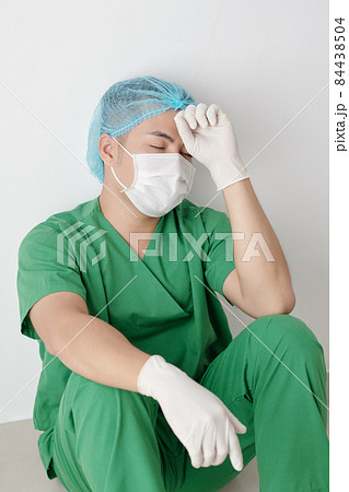 Stressed Nurse Sitting on the Floor Stressed Nurse Sitting on the Floor 84438504