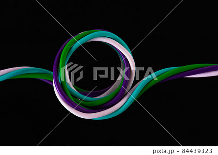 Swirl of telecommunication electrical cable wire isolated on black background Swirl of telecommunication electrical cable wire isolated on black background 84439323