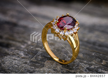 Gemstone jewelry golden ring. 84442657