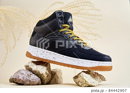 Male winter shoes on beige background Male winter shoes on beige background 84442907