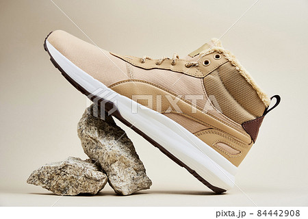 Male winter shoes on beige background 84442908