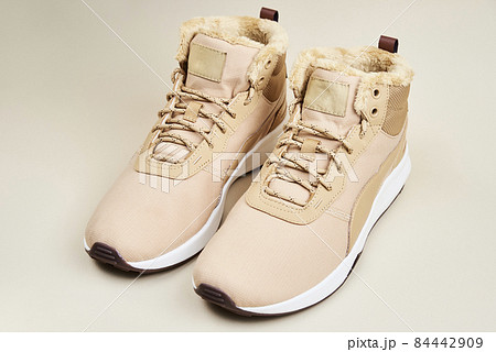 Male winter shoes on beige background 84442909