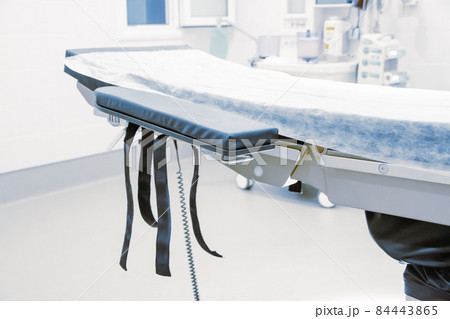 Empty operating room in a hospital. Surgical equipment with operating table. Medical device for emergency patient in blue tone style. Blank Emergency Surgery Room. Clinic interior for background. 84443865