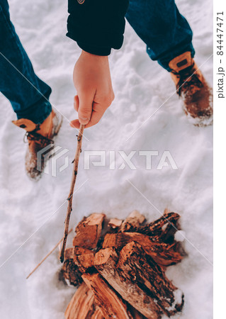 man kindle a bonfire, campfire. winter barbecue theme man kindle a bonfire, campfire. winter barbecue theme 84447471