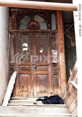 An old wooden door in an abandoned house. An old wooden door in an abandoned house. 84447606