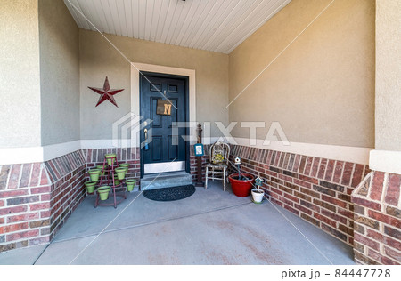 Front door exterior with decorative displays and pots 84447728
