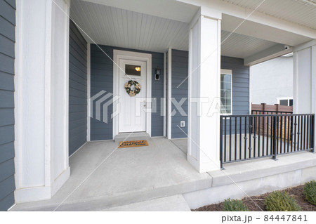 Exterior of a front porch of a house with gray and white tones 84447841