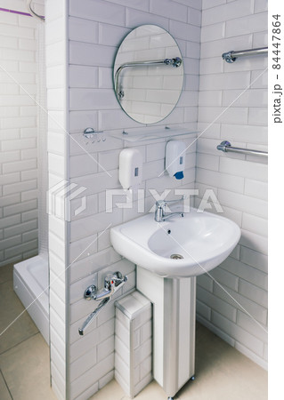 View of a new toilet and bathroom interior for hospital, white and clean View of a new toilet and bathroom interior for hospital, white and clean 84447864