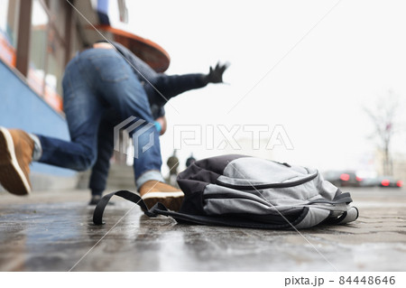 Person get injury after falling on slippery ground in winter season 84448646