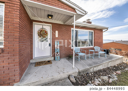 Exterior of an elevated house with bricks and decorative displays 84448993