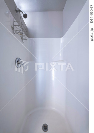 Shower area with a knob and rack under the shower head. Shower area with a knob and rack under the shower head. 84449047