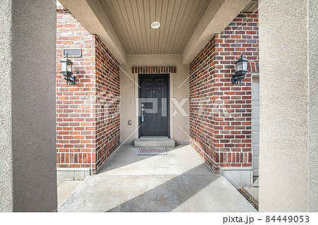 Front door entrance exterior in the middle of red brick walls 84449053