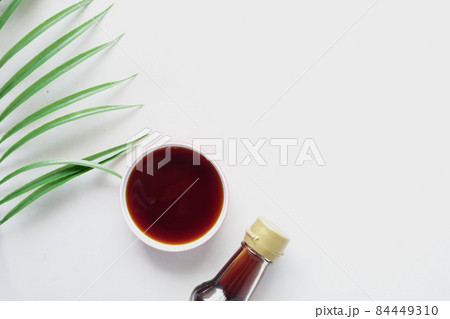 soy sauce in a container with leaf on white background soy sauce in a container with leaf on white background 84449310