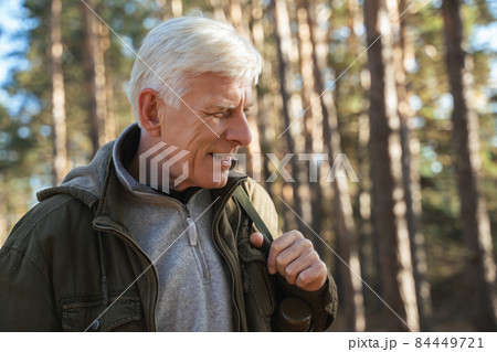 Cheerful old man feeling freedom while traveling in forest 84449721
