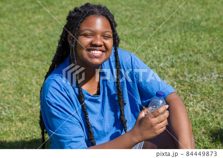 Smiley African-American woman resting after training 84449873
