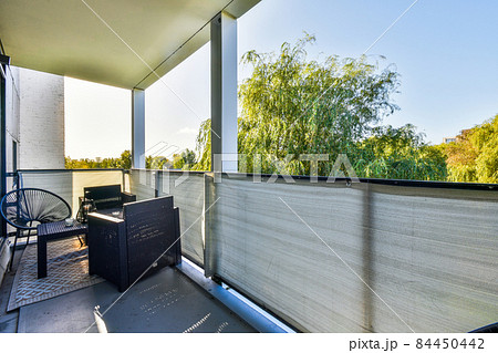 Luxurious balcony with wicker chairs and coffee table Luxurious balcony with wicker chairs and coffee table 84450442