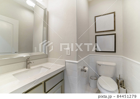 Interior of a bathroom with built-in sink with cabinet and mirror 84451279