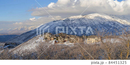 Large houses on top of a snowy hill with Mount Timpanogos view at Draper, Utah 84451325