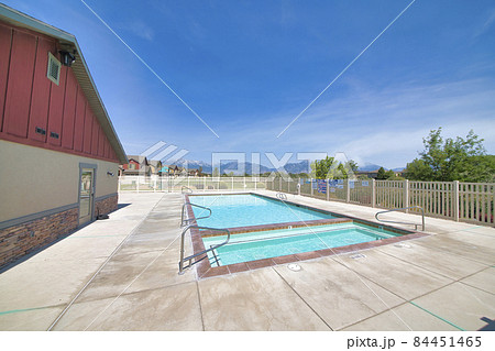 Residential community adult and kid swimming pool with mountain and sky view Residential community adult and kid swimming pool with mountain and sky view 84451465