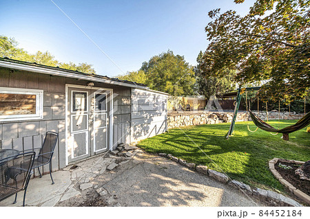 Tool shed at the backyard with cracked concrete flooring at the entrance Tool shed at the backyard with cracked concrete flooring at the entrance 84452184