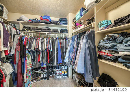 Small walk in closet with hanging rods and shelves Small walk in closet with hanging rods and shelves 84452199