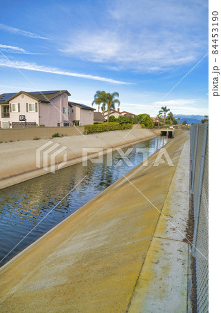 Storm drain with rain and ground water from the streets of the neighborhood 84453190