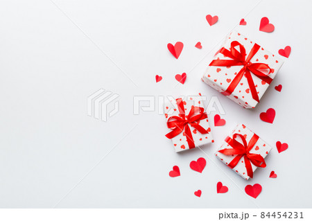 Valentine day composition: red gift box with bow and heart. Christmas present. View from above. Space for text. Holday greeting card 84454231