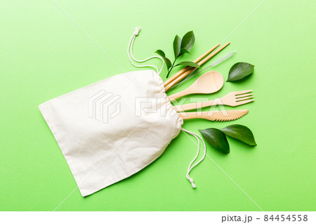 Eco friendly reusable recyclable white eco bag with kitchenware on Colored background. Concept zero waste Eco friendly reusable recyclable white eco bag with kitchenware on Colored background. Concept zero waste 84454558